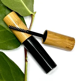 Dab Herb Make-up mascara brand container laying on green leaf embracing sustainable zero waste mascara