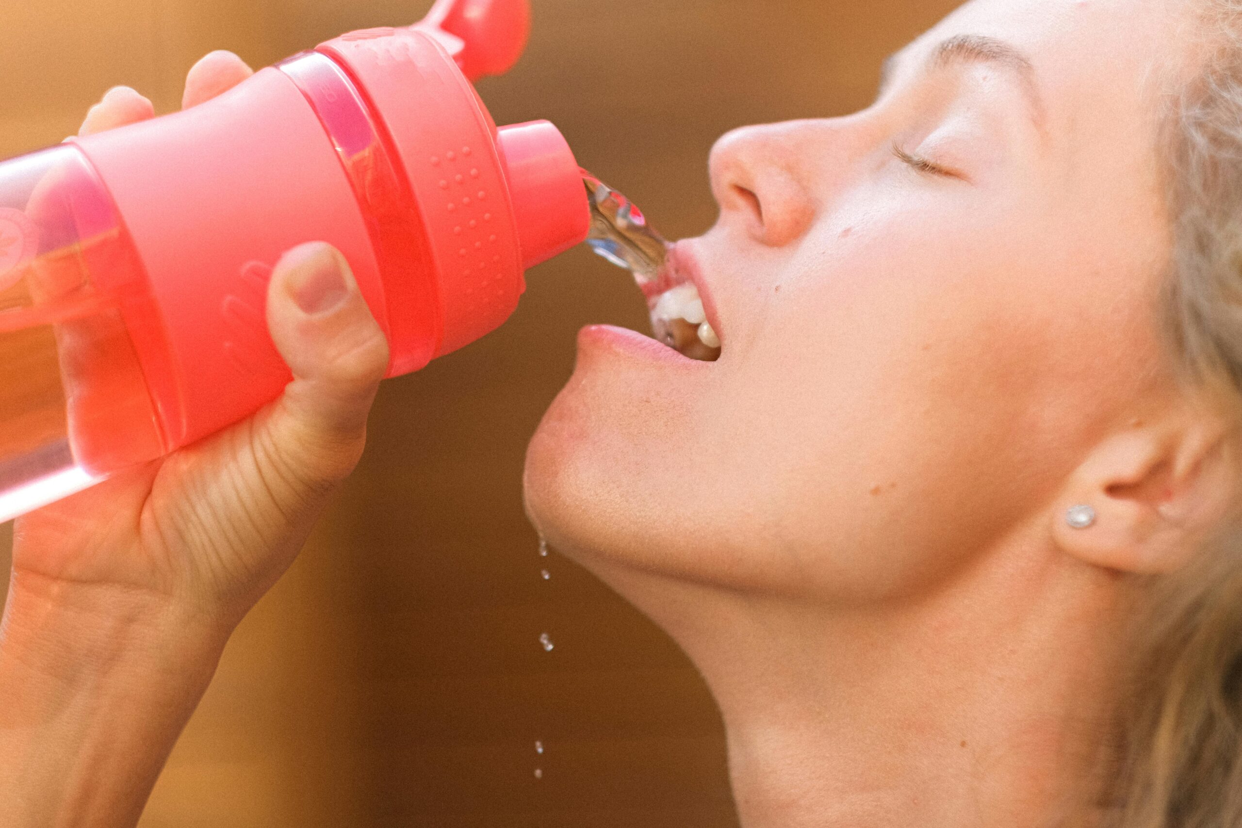 water pouring from reusable water bottle. Embracing better taste from a reusable, non-plastic, water bottle.