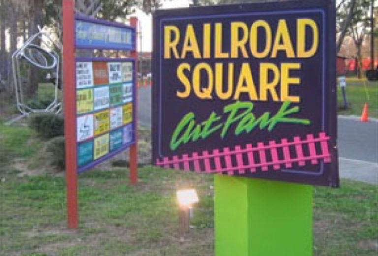 Sign that says 'Railroad Square Art Park' embracing the community involvement of 'The Other Side Vintage'