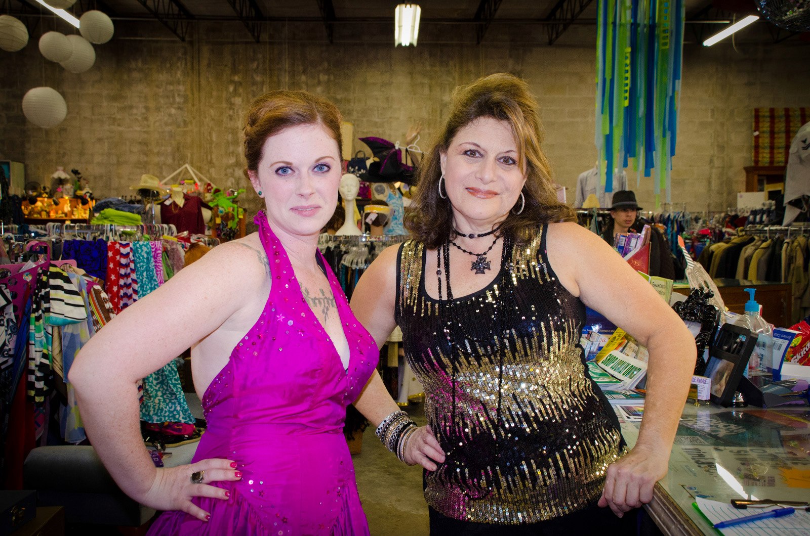 Two ladies wearing items from a thrift store. 