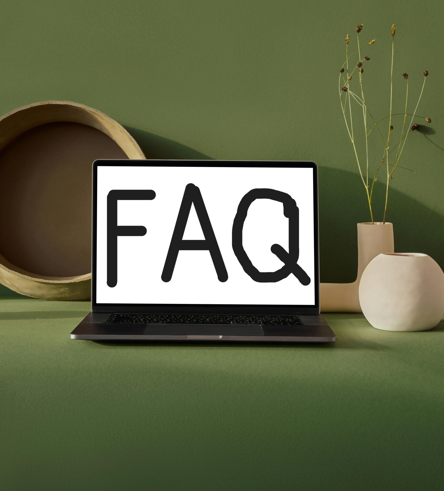 computer screen displaying the letters FAQ, which is short for frequently asked questions.