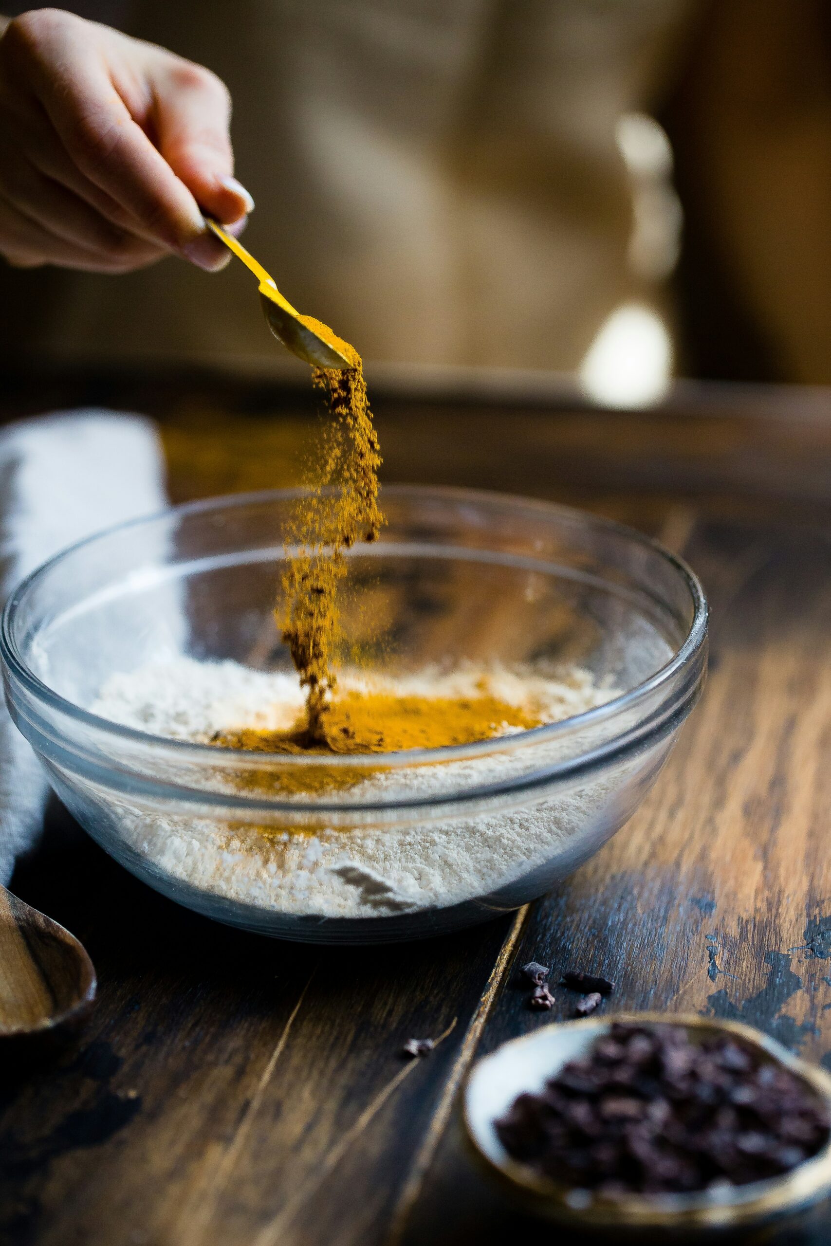 spices being poured into glass bowl embracing eco friendly spice packaging