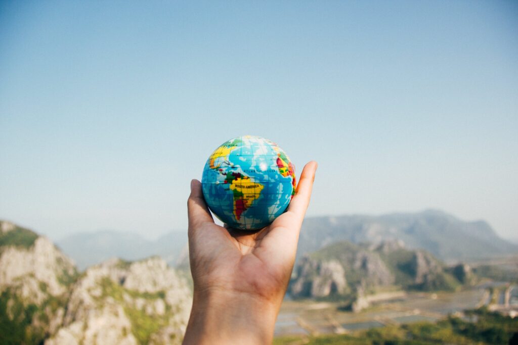 hand holding a globe, embracing sustainable living