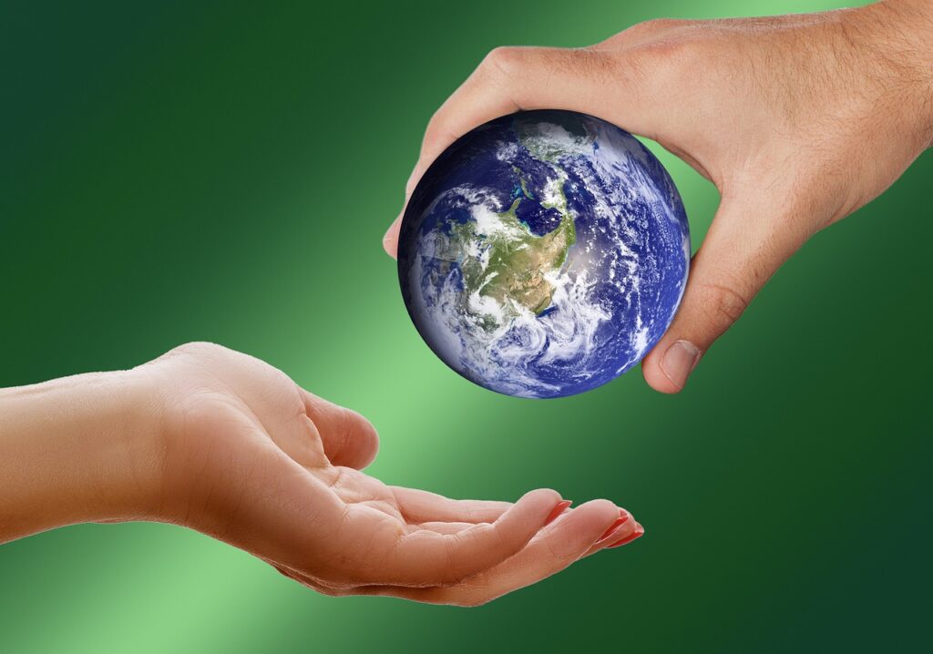 two hands exchanging a globe, embracing sustainable living