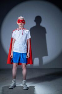 kid wearing super hero outfit, embracing thrift store outfit ideas