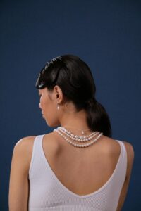 female wearing vintage pearl necklace and earings
